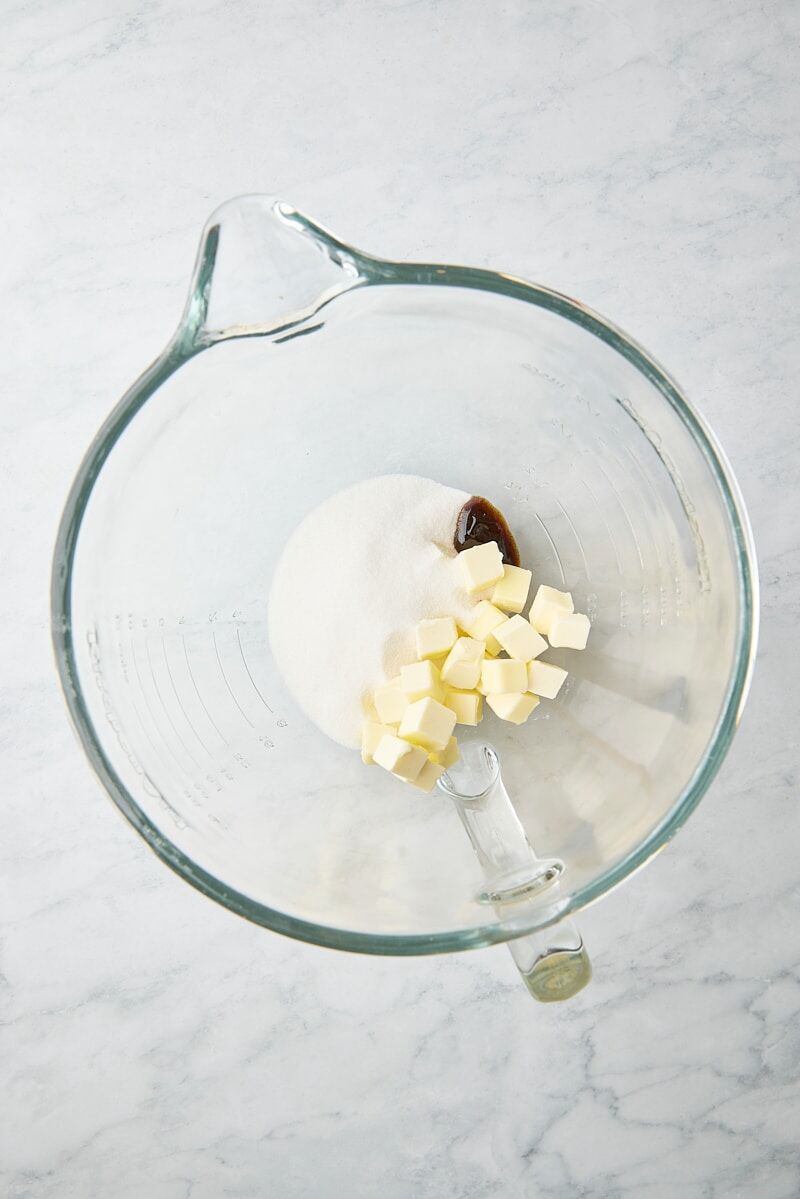 Butter, granulated sugar, and vanilla in glass mixer bowl