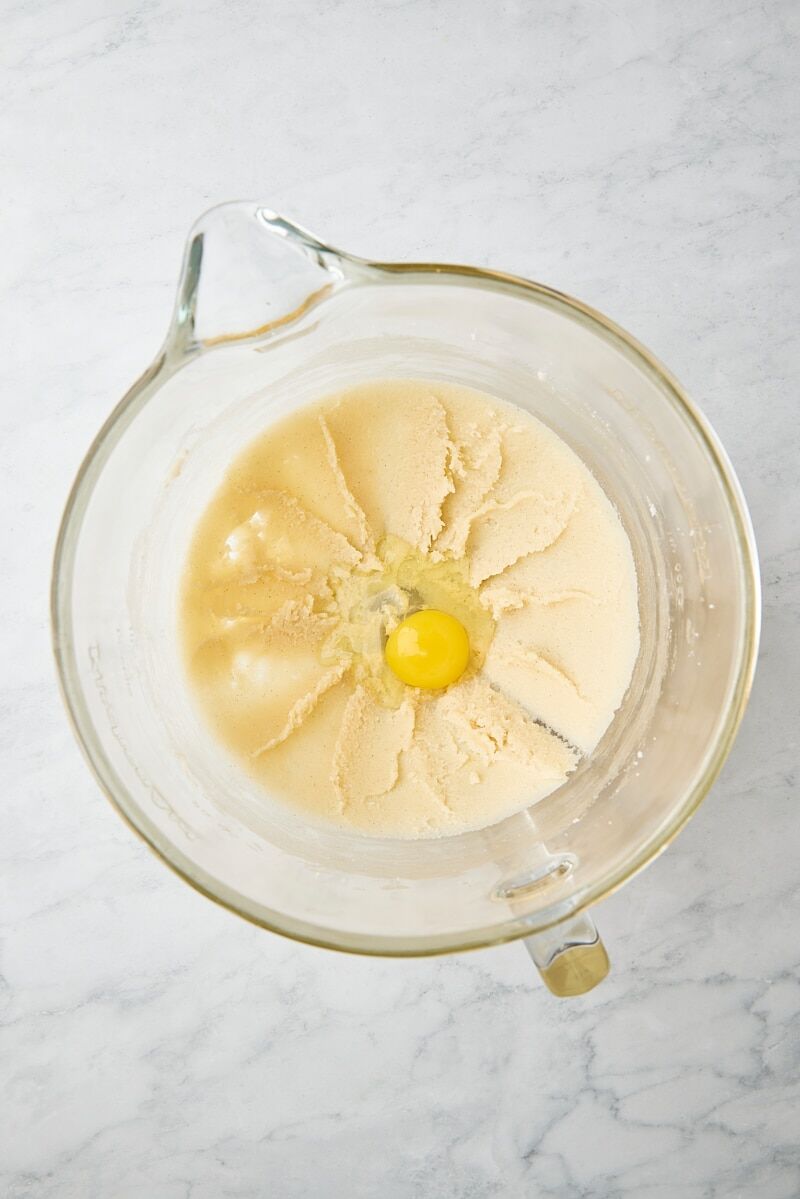 Egg added to batter in glass mixer bowl