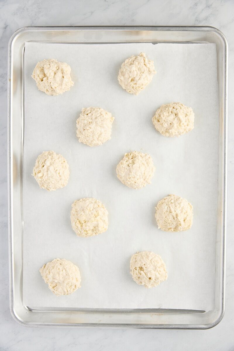 Unbaked biscuits on parchment-lined baking sheet