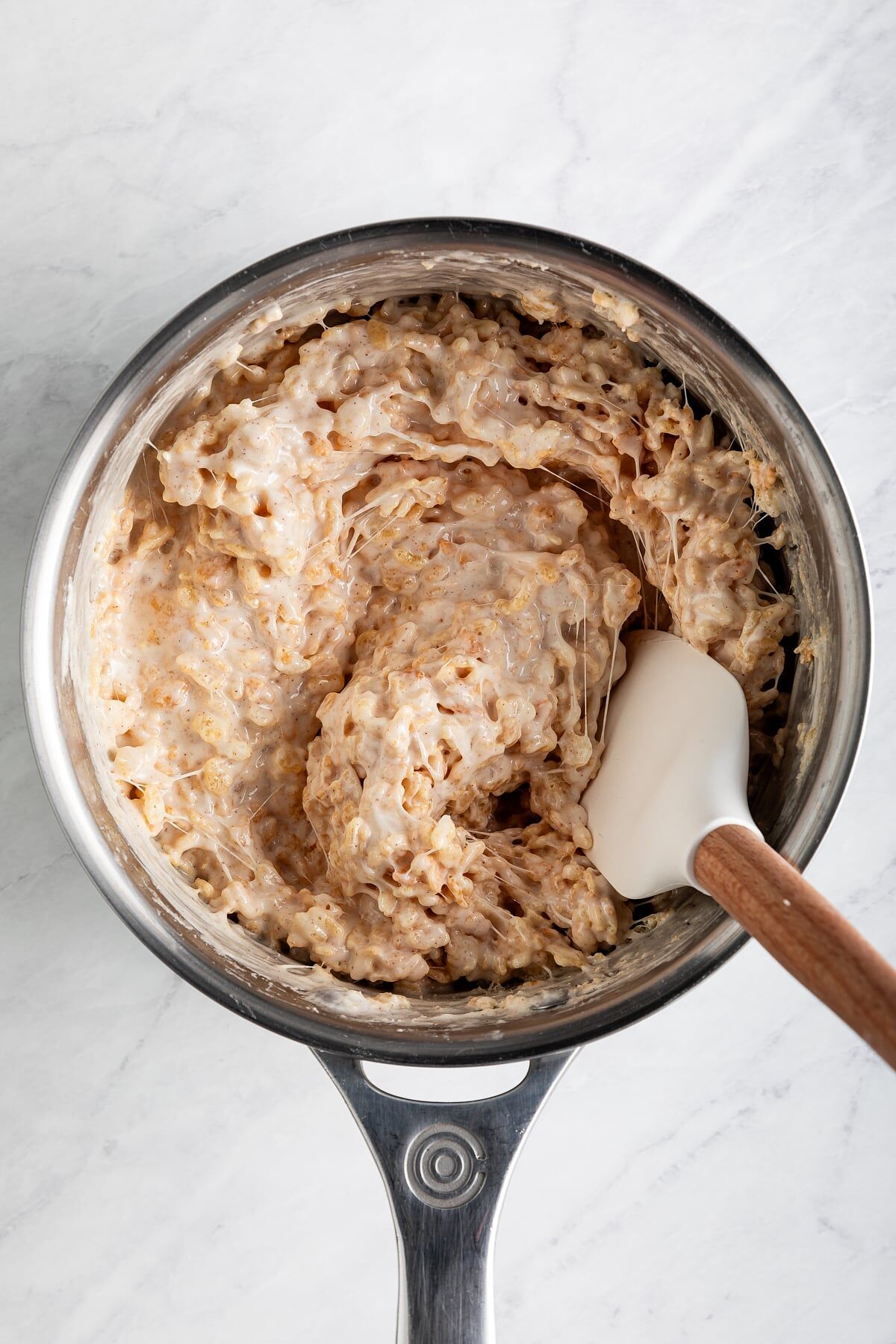 Crisp rice cereal folded into melted marshmallow mixture with spatula