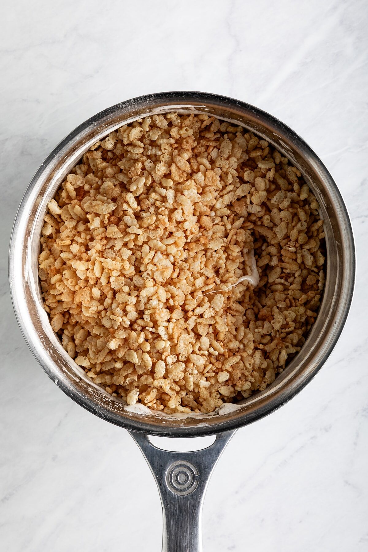 Crisp rice cereal added to melted marshmallow mixture