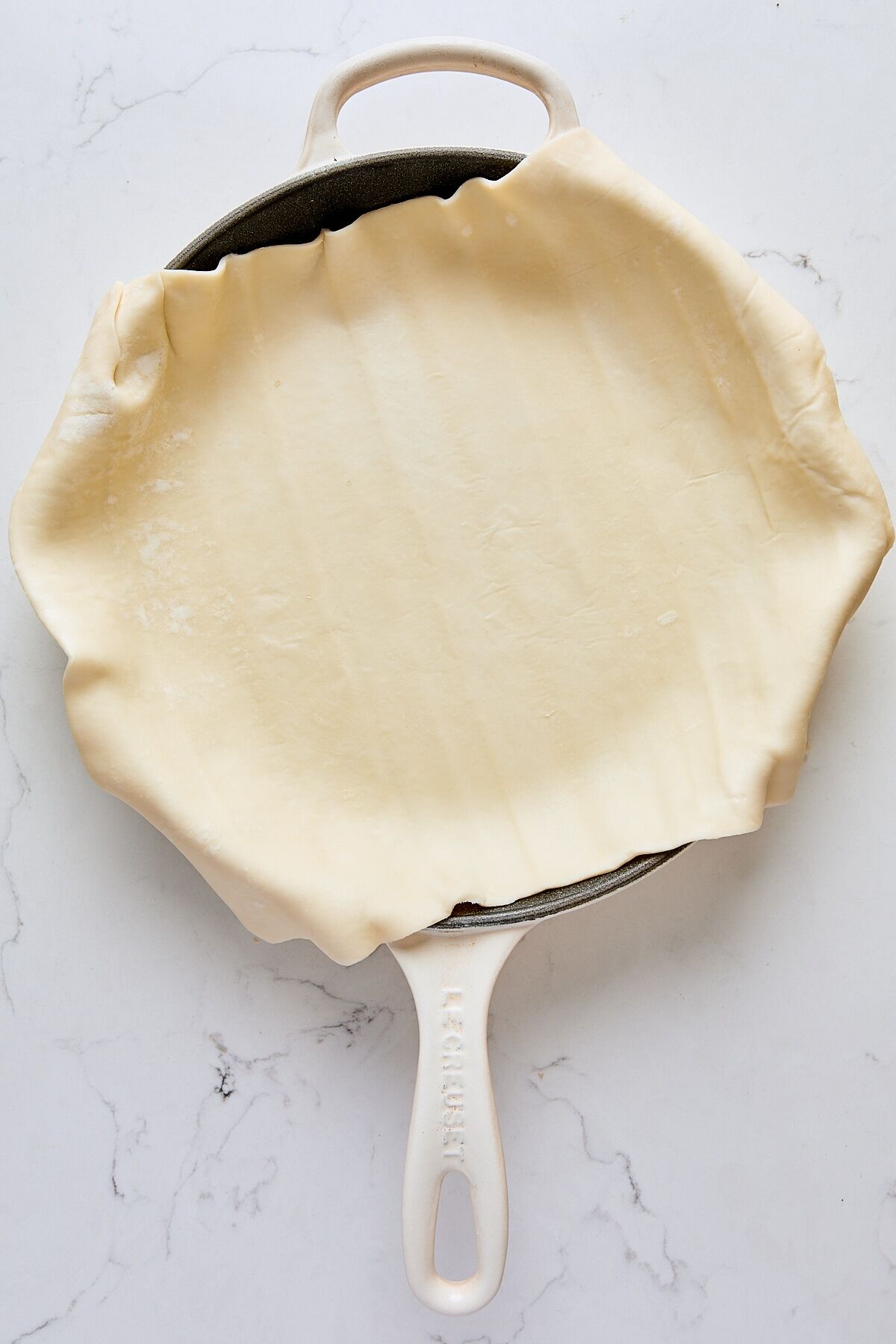 Puff pastry sheet in cast iron skillet